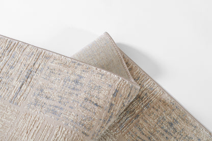 Beige & blue textured area rug with abstract linear pattern; woven, soft pile, modern décor.