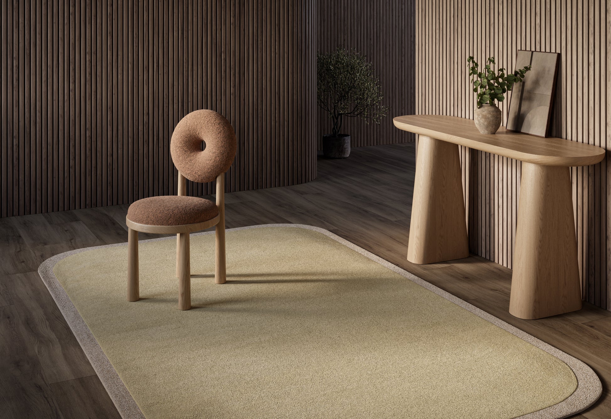 Minimalist living room with beige rectangular rug, round-back upholstered chair, curved wooden console, plant on top.