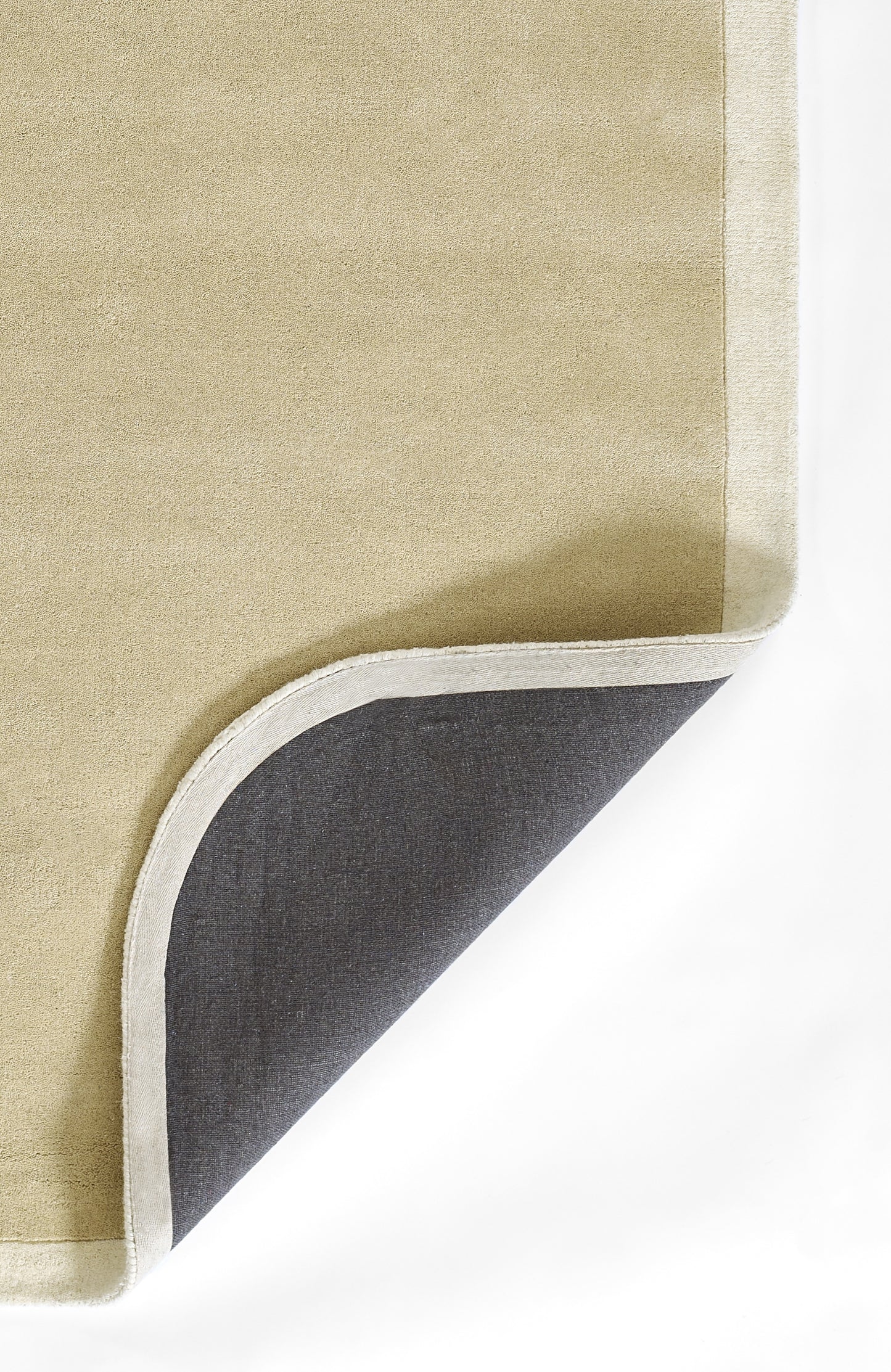 Beige flatweave rug with light gray edge trim; corner turned to reveal dark gray underside.