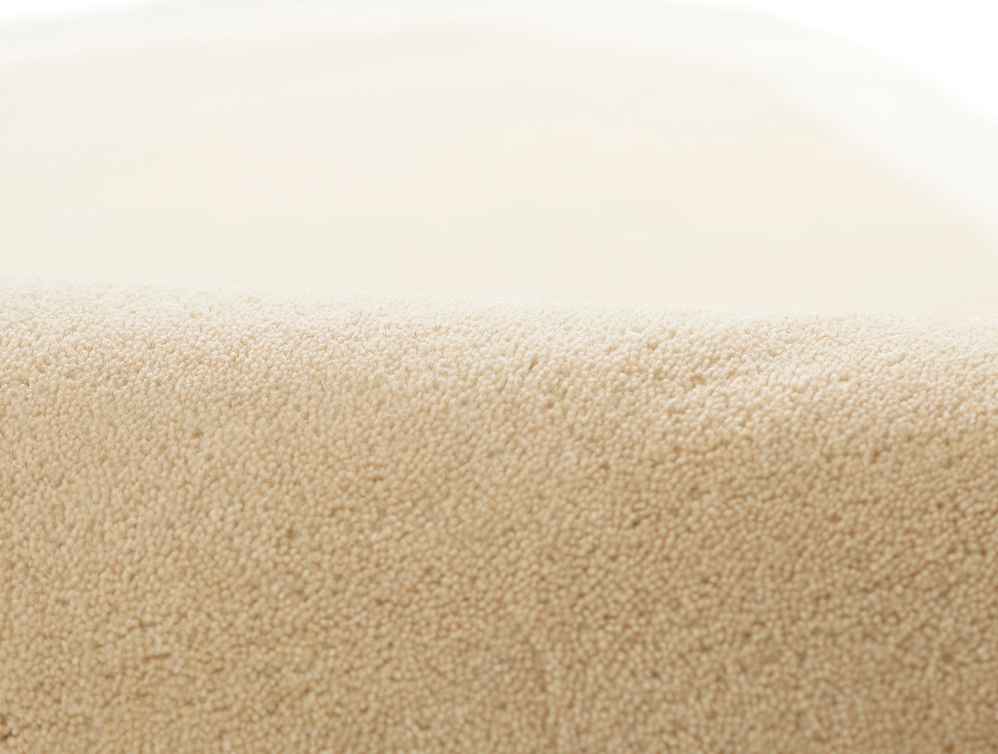 Beige rug close-up showing plush looped pile texture.