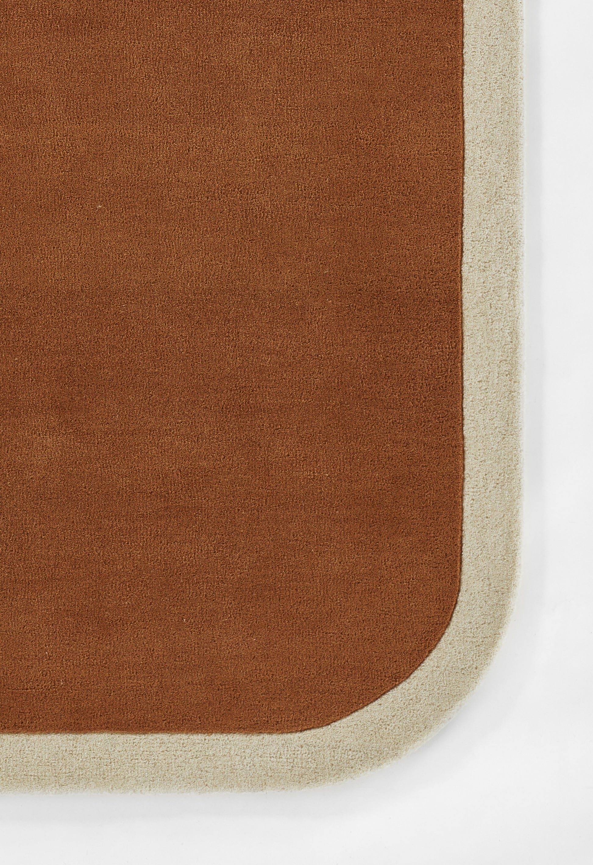 Brown rectangular rug runner with a pale beige border and rounded corner.