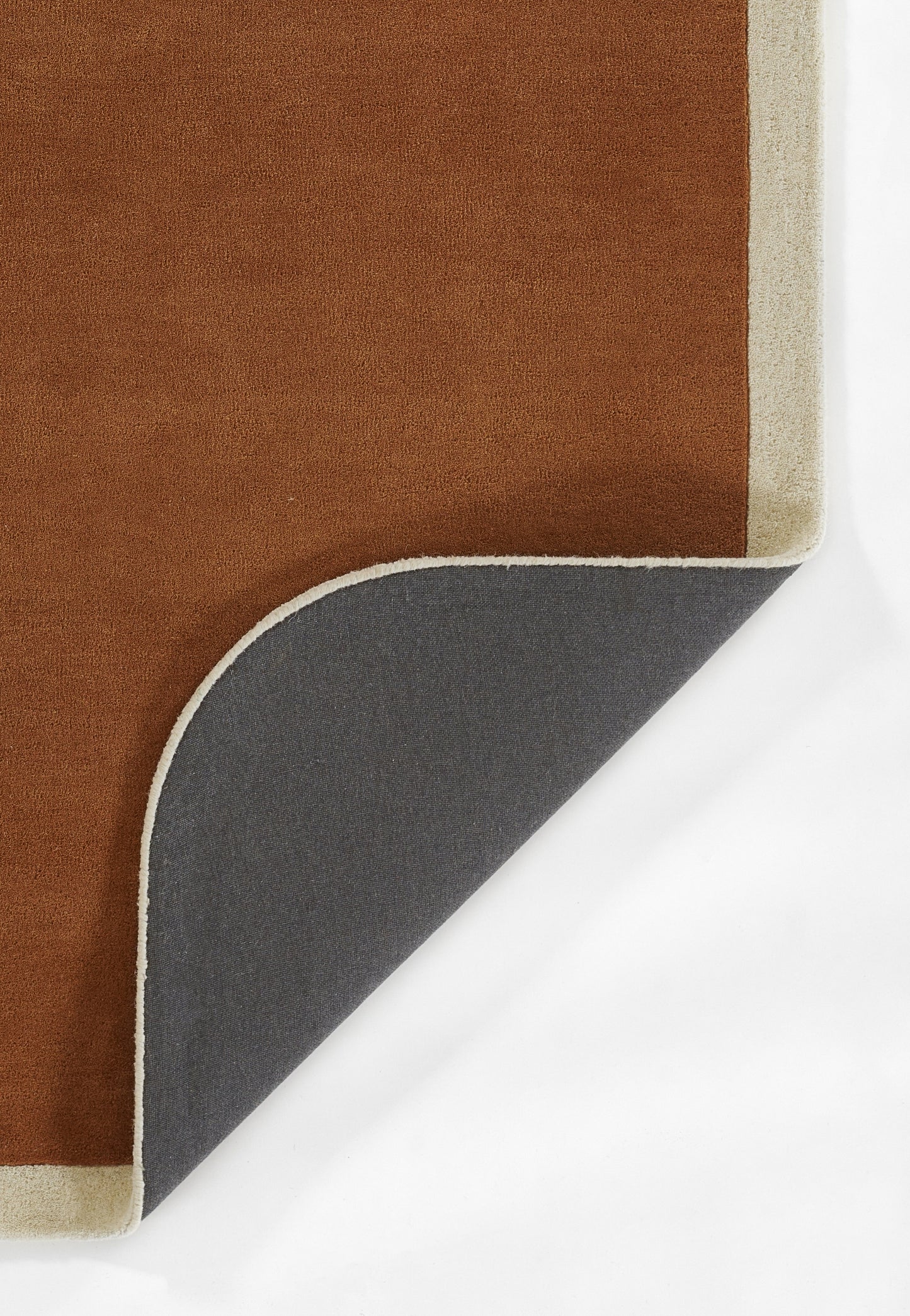 Brown rectangular rug with beige binding, folded to show dark gray underside and curved corner.