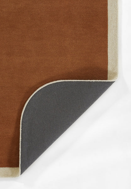 Brown rug with beige edge, folded corner reveals dark gray underside.