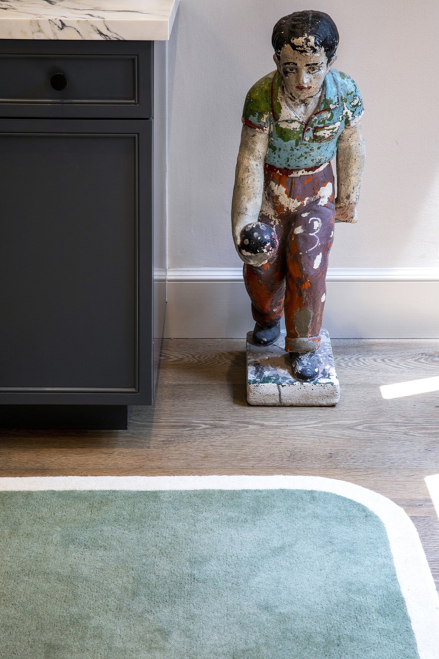 8' x 10' rug on a wood floor with a muted earthy pattern.