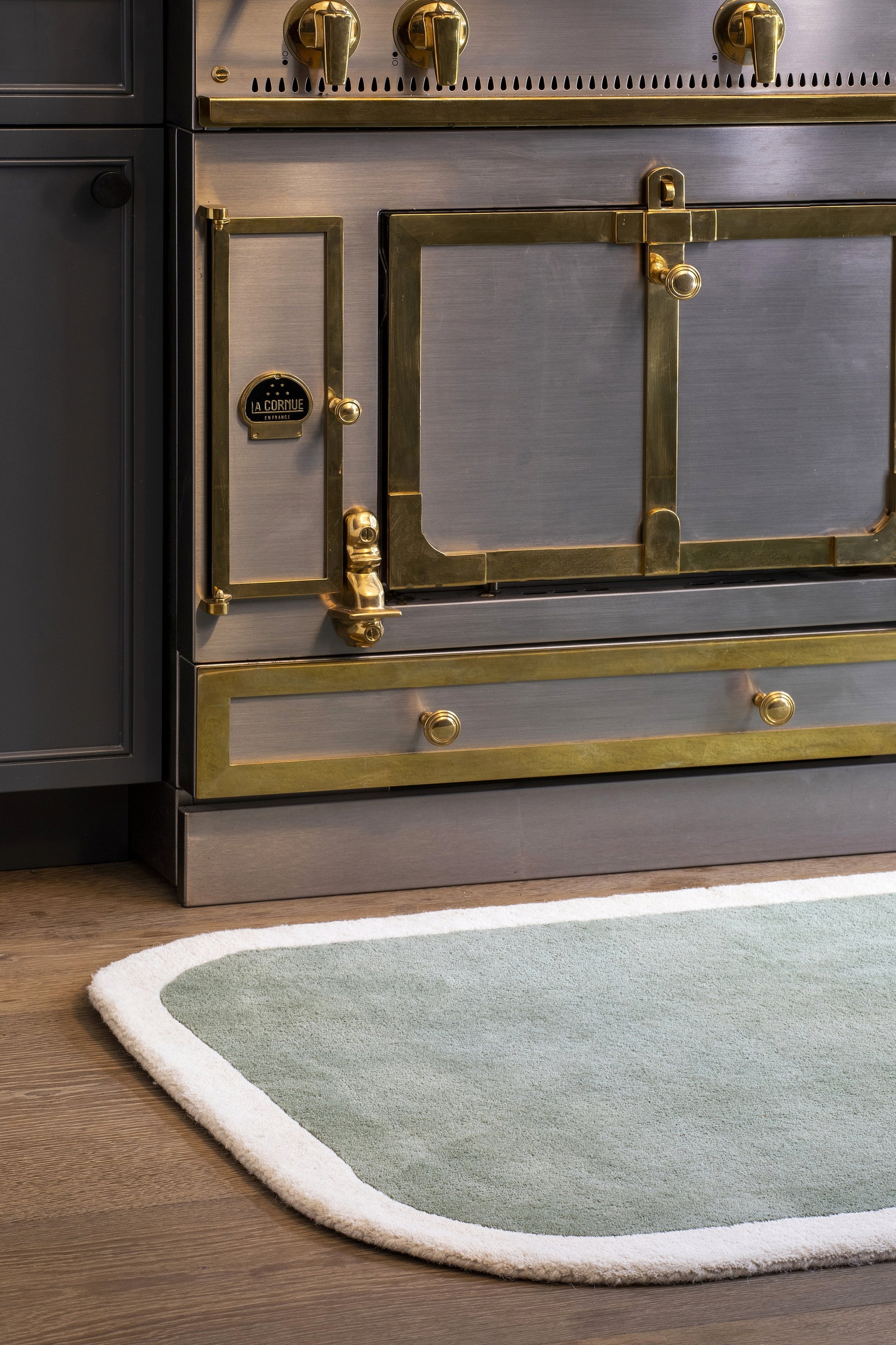 Green-gray rug with a white edge in the foreground.