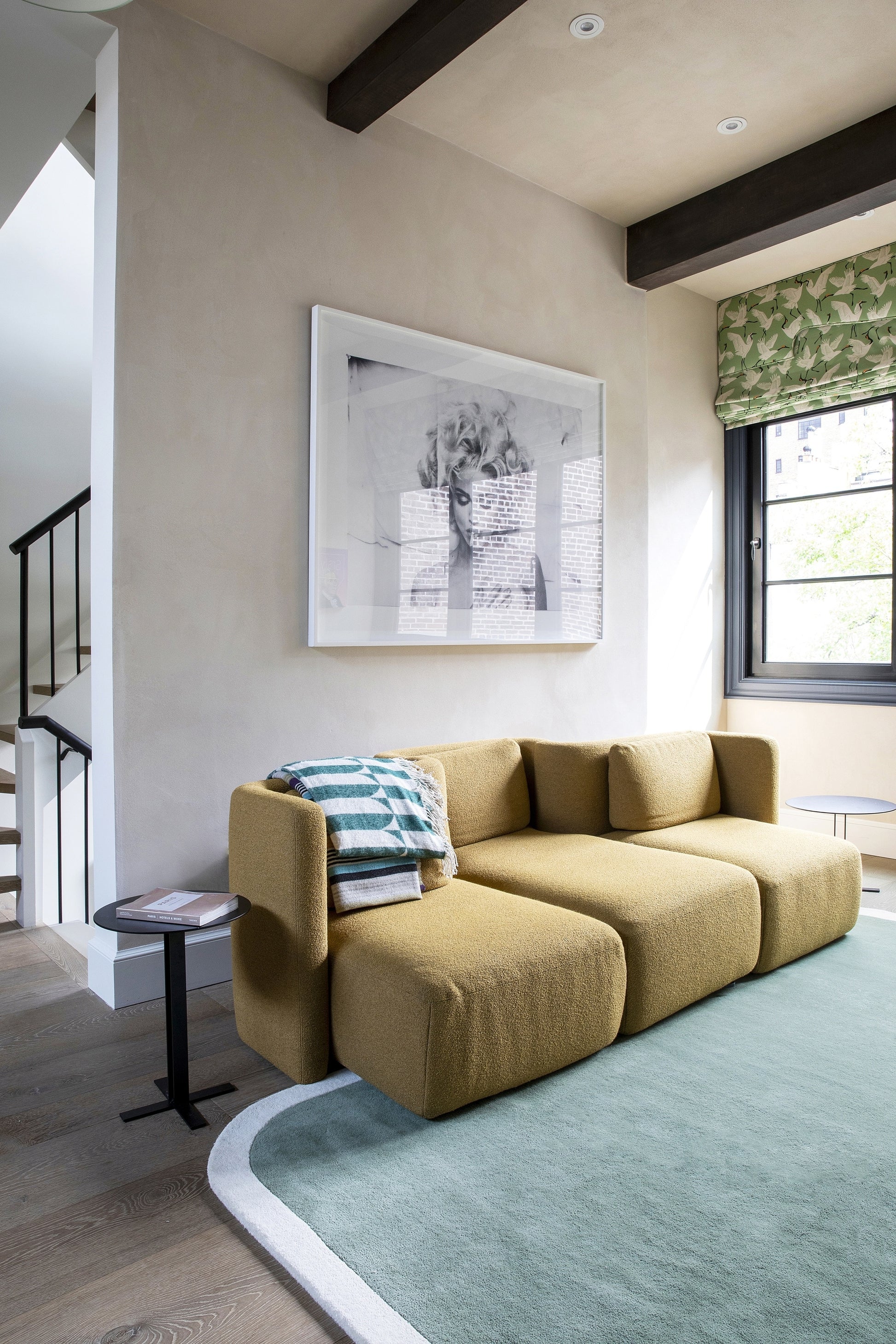 Mint rug 2' x 4' in a modern living room with a mustard-yellow modular fabric sofa in three sections and a teal plaid throw.