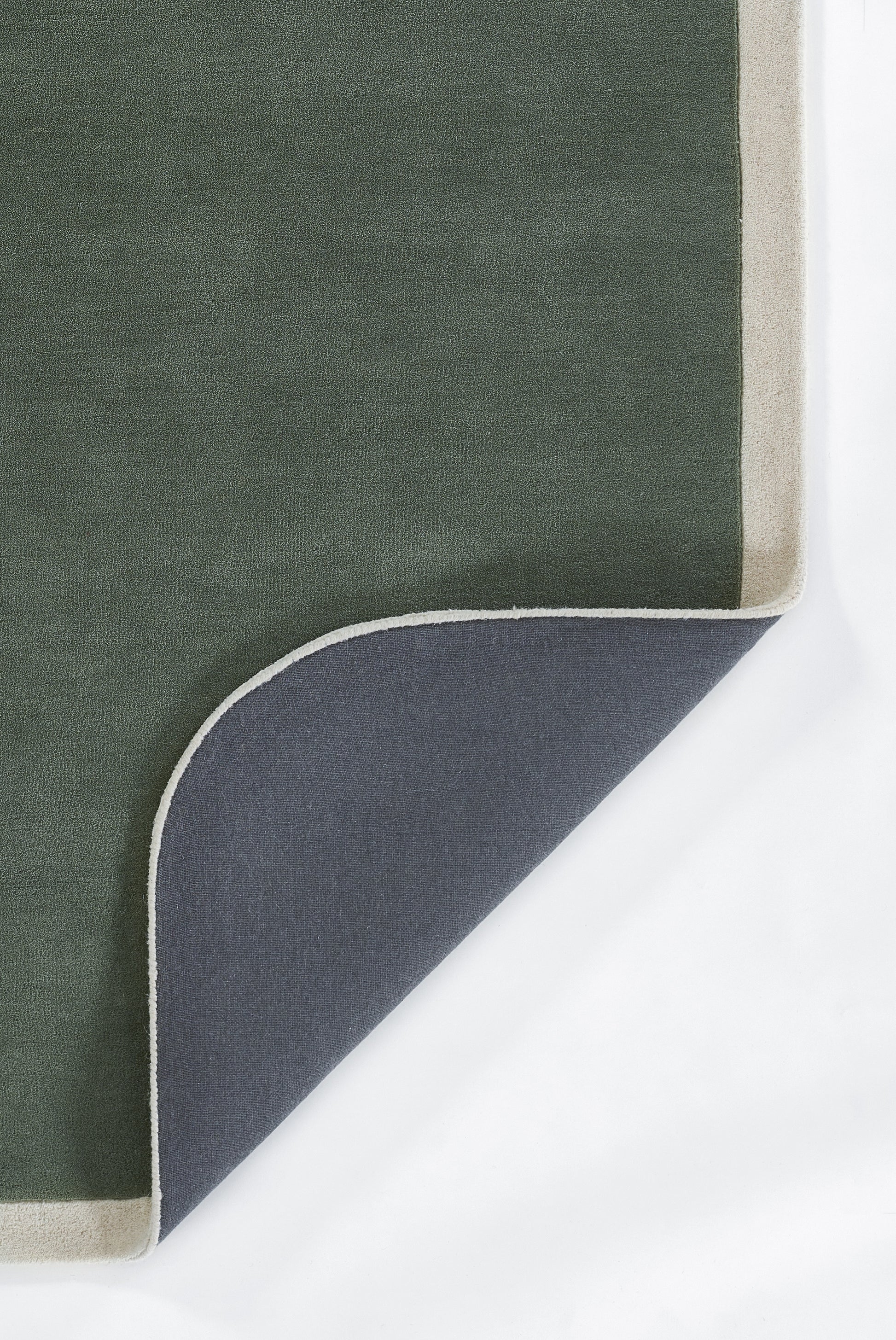 Olive green rug with beige border; corner folded to reveal navy underside with white trim.