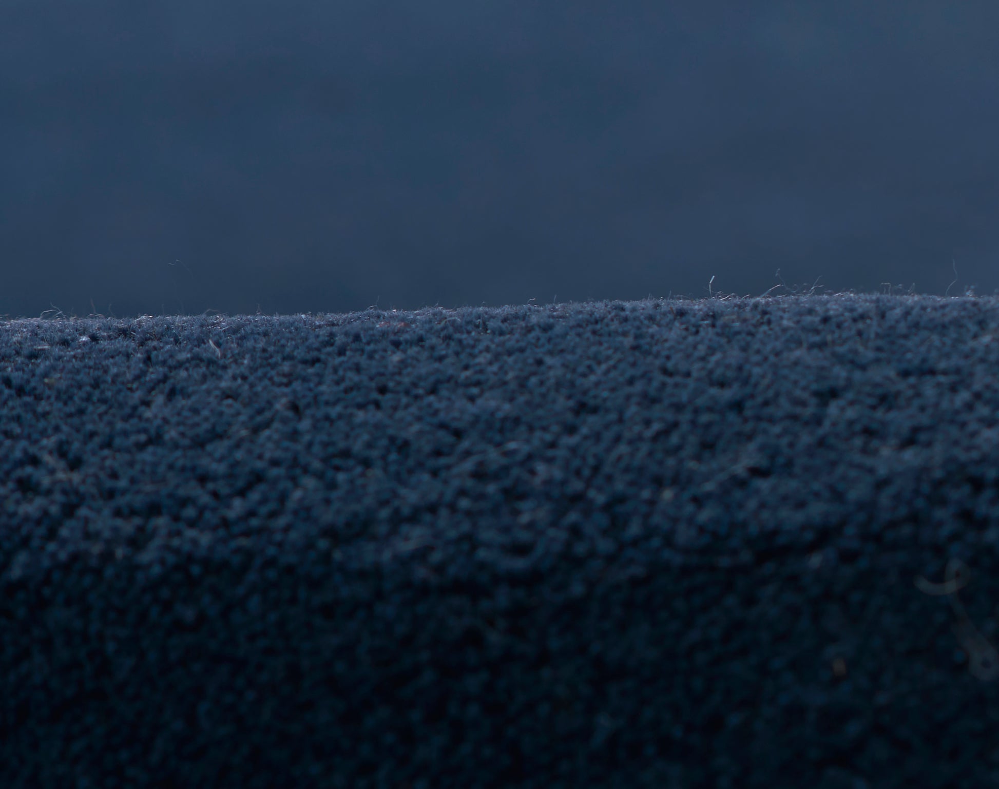 Close-up of navy blue velvet rug runner with soft, plush pile and fine texture.