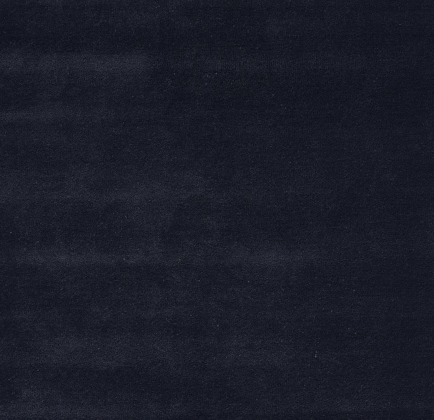 Dark navy velvet fabric with a soft nap, luxe texture; ideal for upholstery or throw blanket.