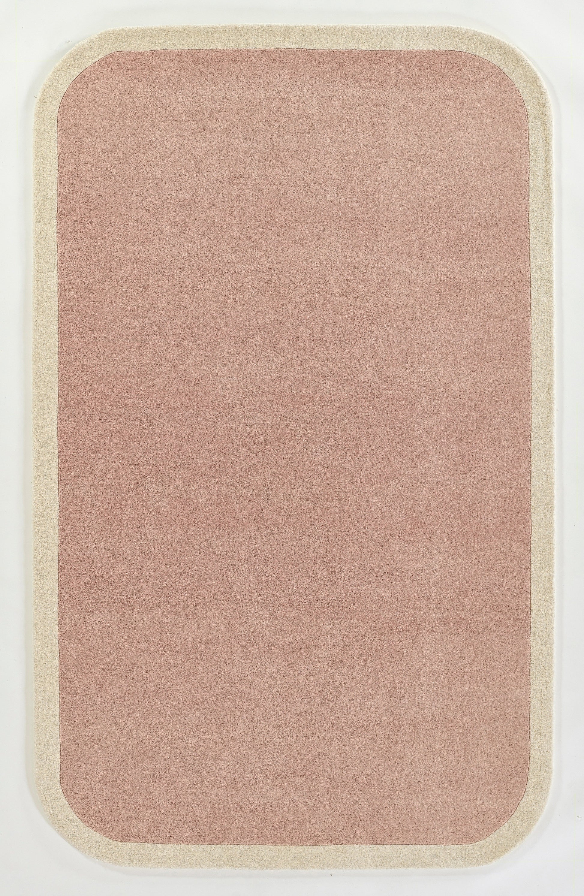Dusty pink rounded-rectangle area rug with cream border for minimalist home decor.