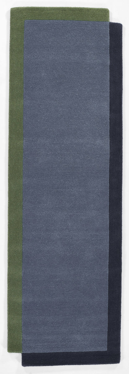 Rug 8' x 10' with an olive green border, blue-gray center, and navy edging; soft terry-pile texture.