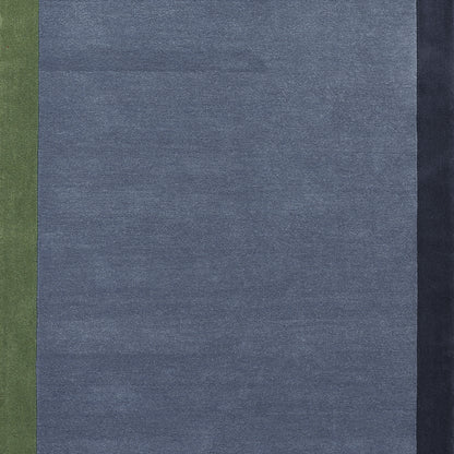 Blue woven rug (4' x 6') with olive green left stripe and dark navy right edge; denim-inspired design.