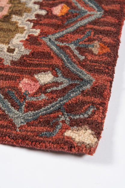 Close-up of a red patterned rug (8' x 10') with blue-gray accents and cream detailing; thick tufted pile.