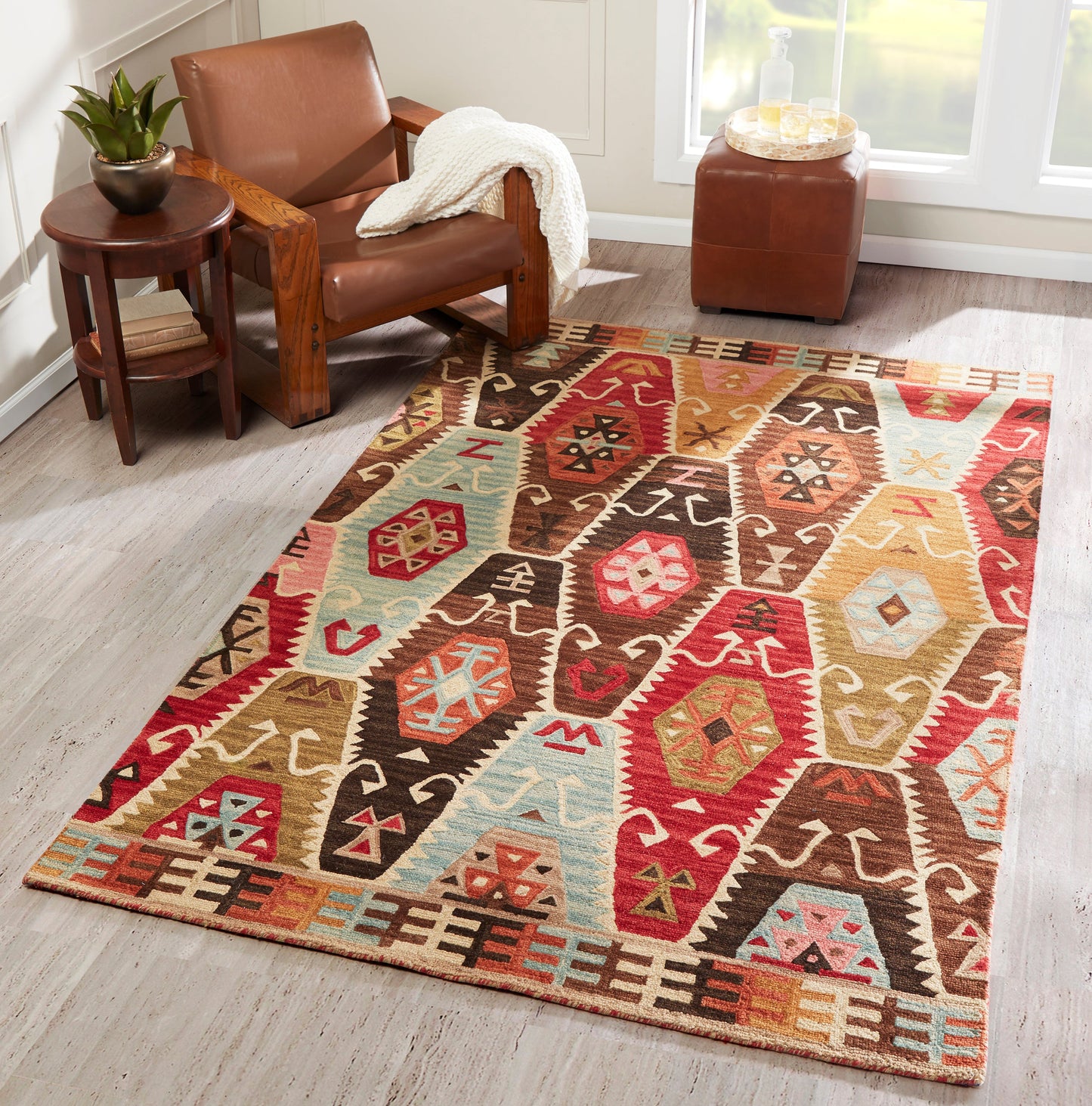 Rectangular kilim-style rug with vibrant geometric motifs in red, teal, brown and beige; woven flatweave for living rooms.