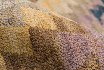 Soft boucle fabric in earthy patchwork of tan, brown, and mauve; chunky textured, cozy home decor.