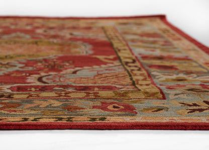 Rectangular oriental rug with red field, gold border, and blue-beige floral motifs; plush woven pile.