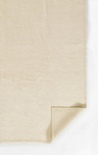 Beige runner rug with soft plush pile and folded corner, 3' x 8'.