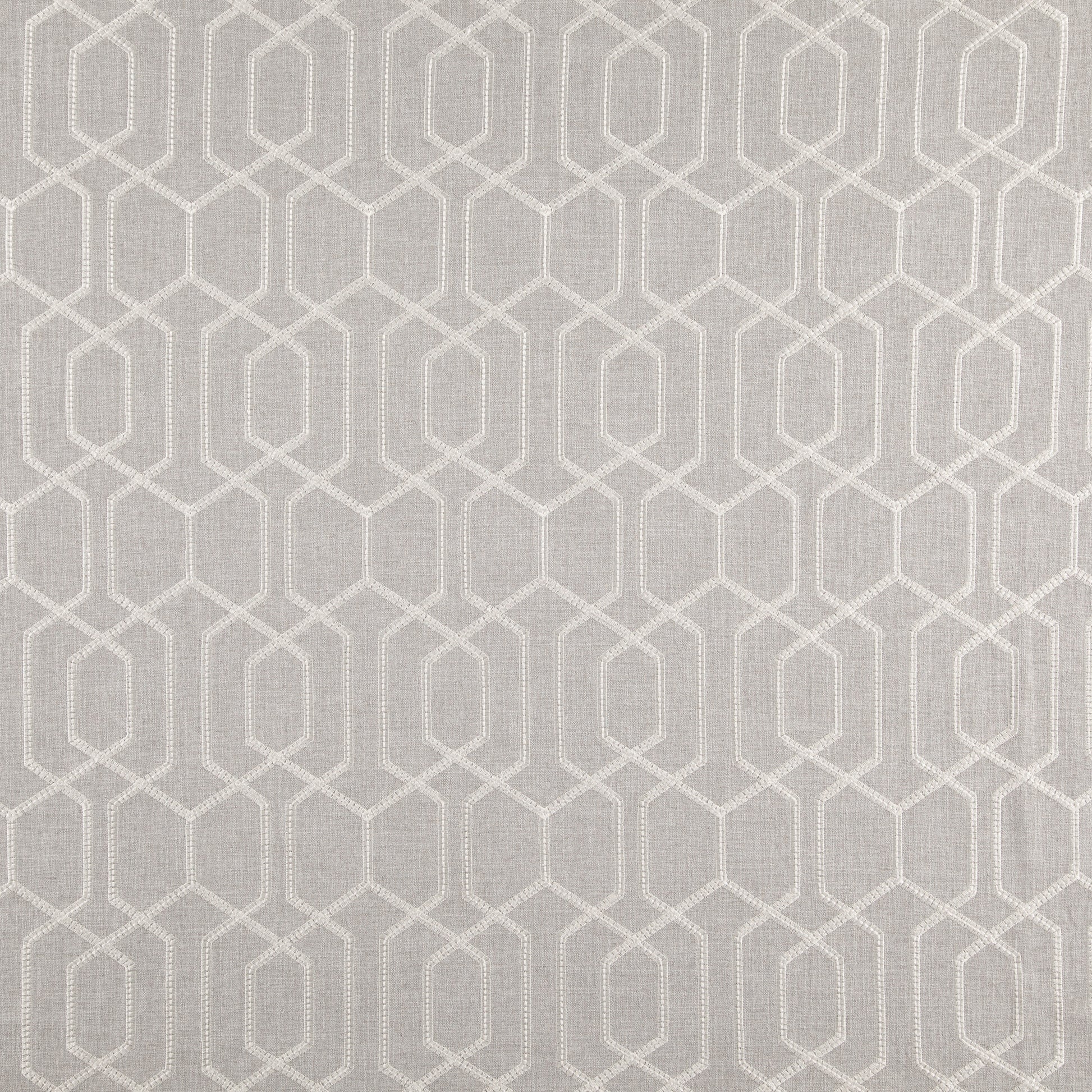 Grey/silver fabric with a cream geometric lattice of interlocking hexagon frames.
