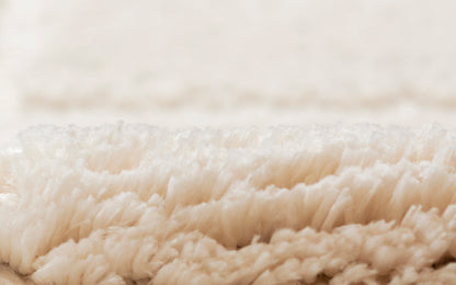 Ivory rug close-up showing soft plush pile.