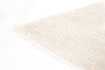 Cream ivory shag rug with subtle striped texture; plush rectangular floor rug.
