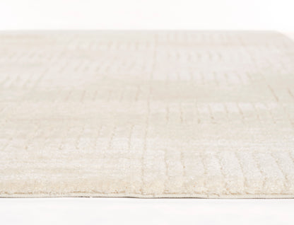 Beige ivory plush rug with subtle geometric pattern, rectangular shape, soft texture for living room decor.
