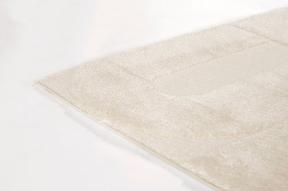 Ivory plush area rug with subtle geometric border, soft textured pile, ideal for living room or bedroom decor.