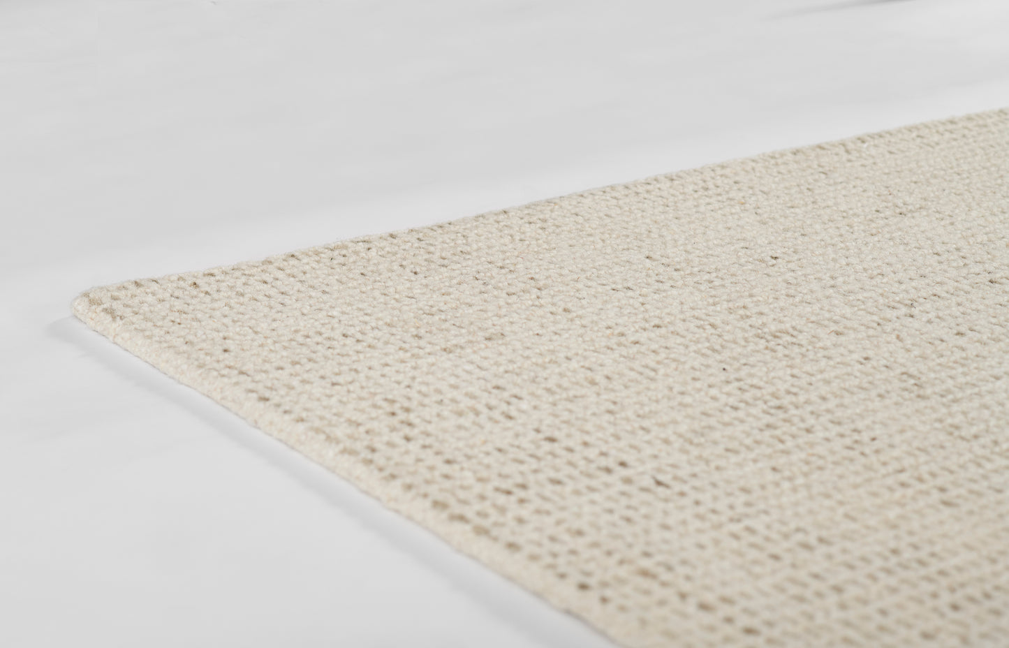 Natural beige woven jute rug, flat-weave, rectangular, rustic boho style for living room or entryway.