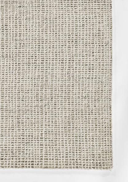 Neutral grey-beige woven rug texture with chunky loop weave; casual modern décor.