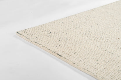 Cream woven jute rug with looped texture and speckled fibers, natural rectangular floor mat.