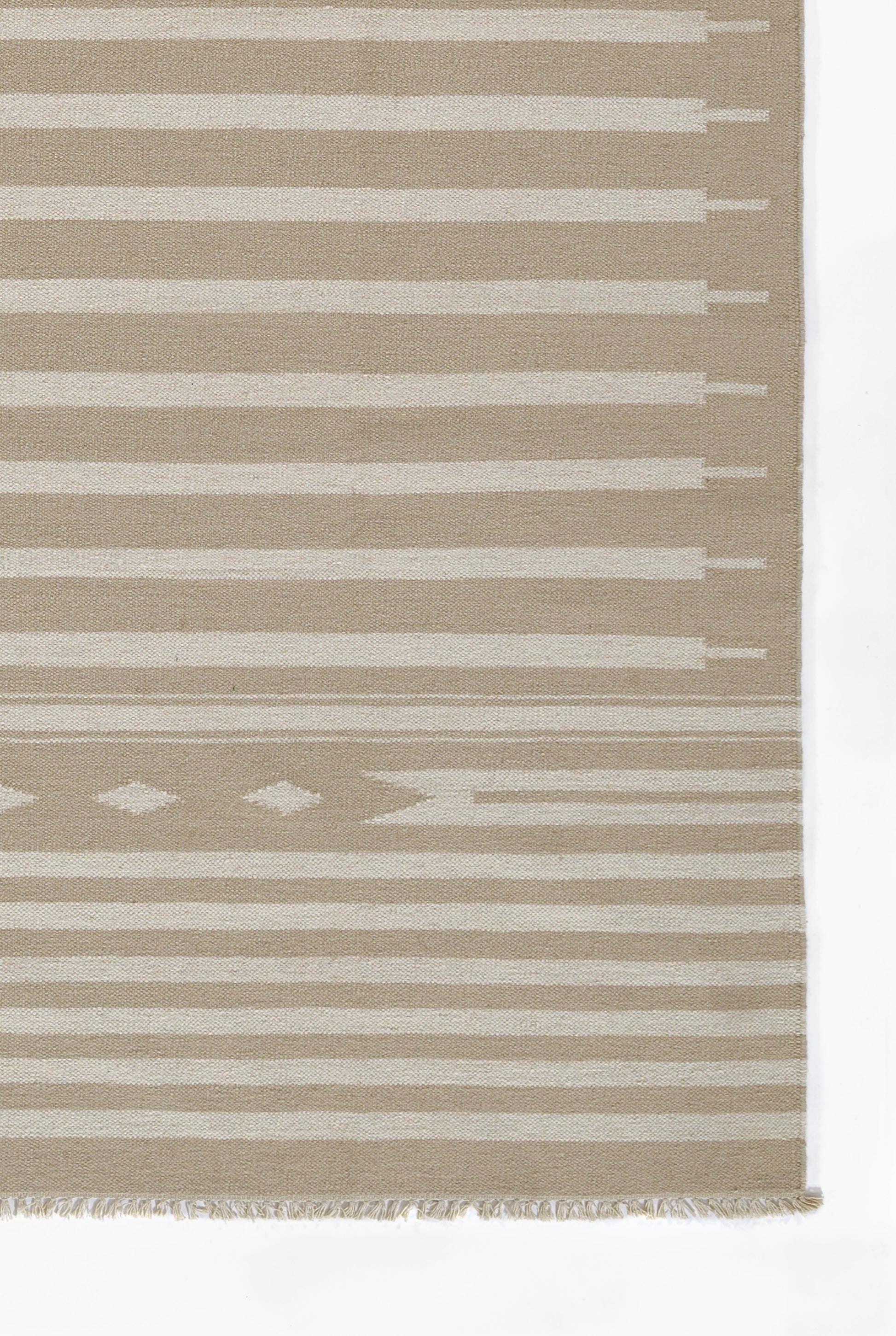 Beige flat-weave rug with cream horizontal stripes and a subtle diamond motif near the bottom, fringed edge.