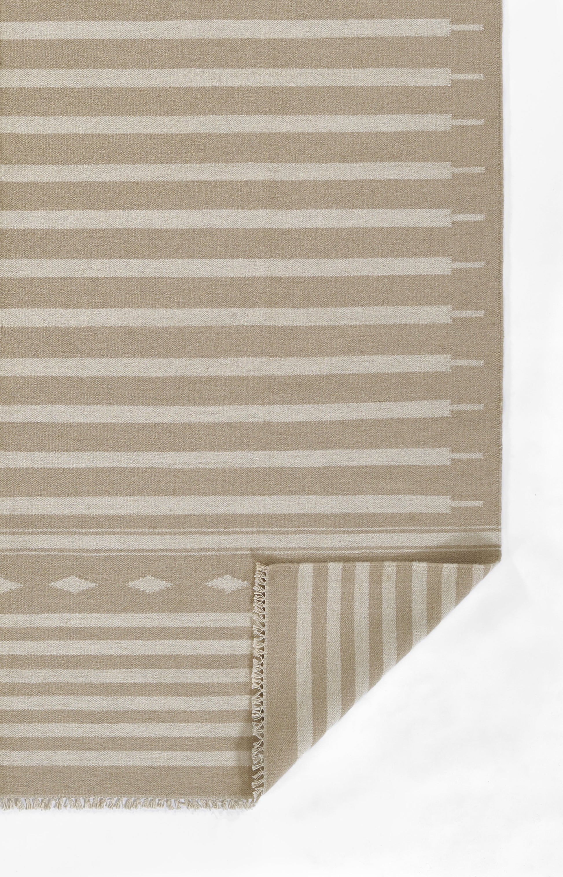 Beige flat-weave rug with white horizontal stripes and a diamond motif near the edge; folded corner shows fringe.