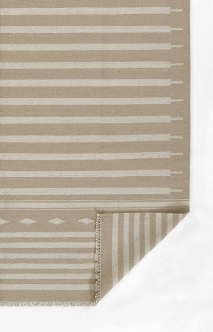 Beige rug with white horizontal stripes, fringed edges; folded corner reveals striped underside.