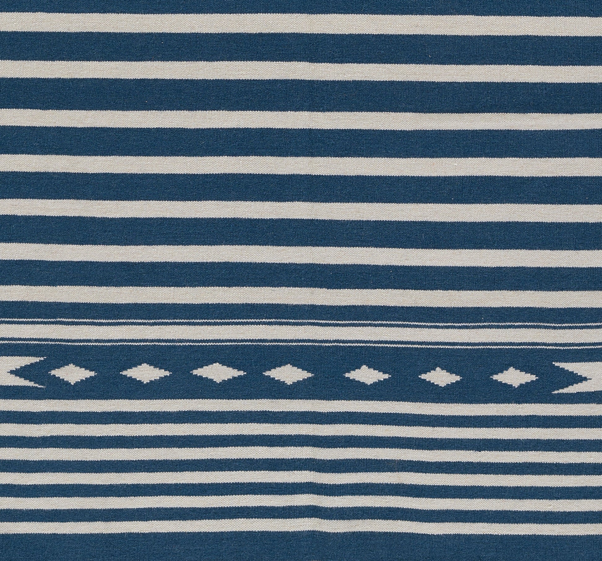 Blue and white striped rug with a central diamond-pattern band in a nautical style, 2' x 3'.