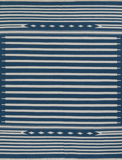 Blue and white striped rug with diamond motif borders and fringed edges.