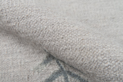 Close-up of a soft gray boucle knit rug runner with fuzzy fibers, cozy and warm texture.