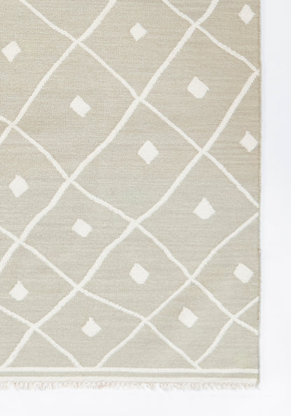 Beige modern geometric rug with white lattice diamonds and small diamond motifs; fringed edge.