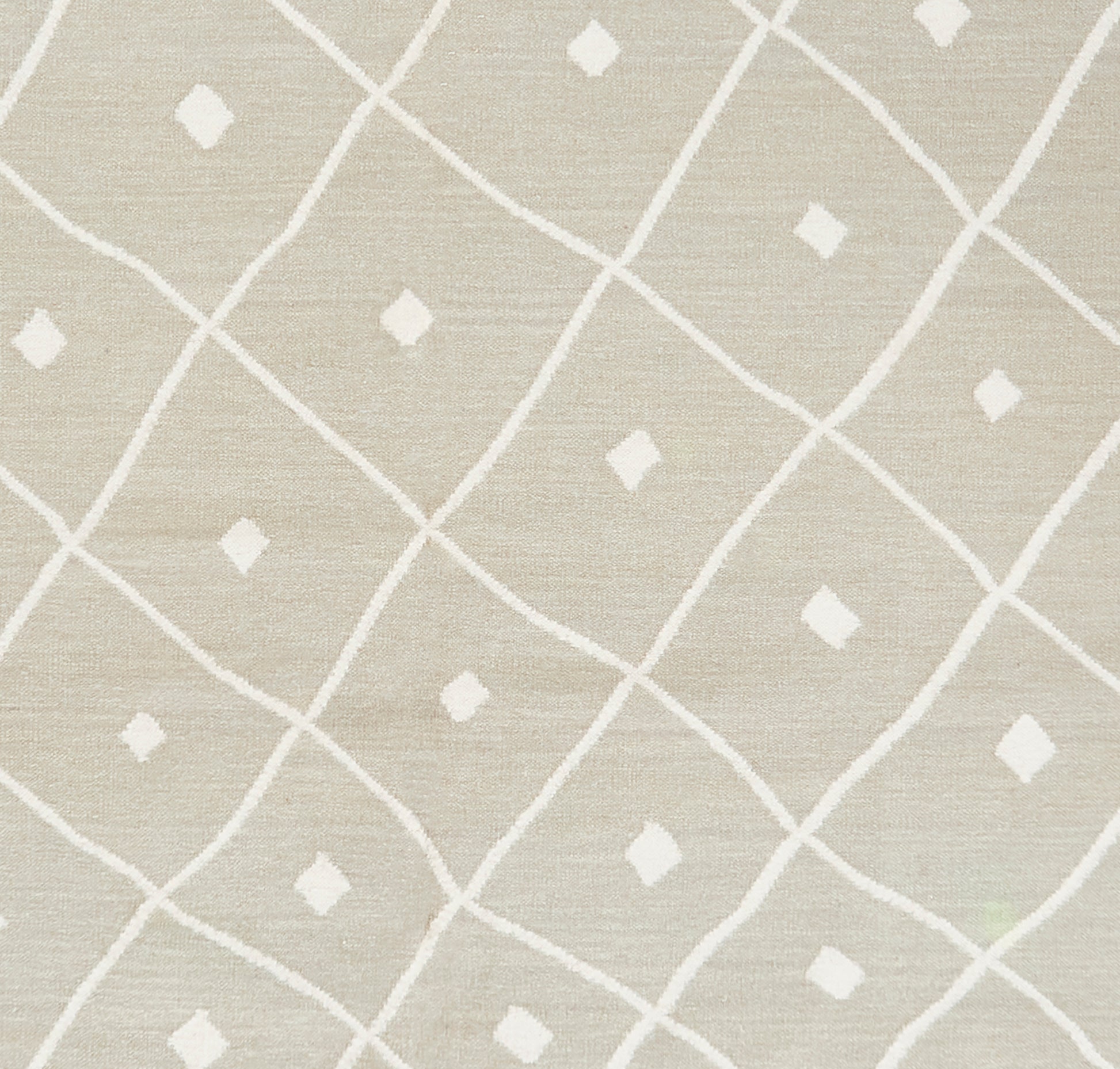 Beige rug with linen-textured weave and a white diagonal lattice pattern with small diamond motifs; 7'6" x 9'6