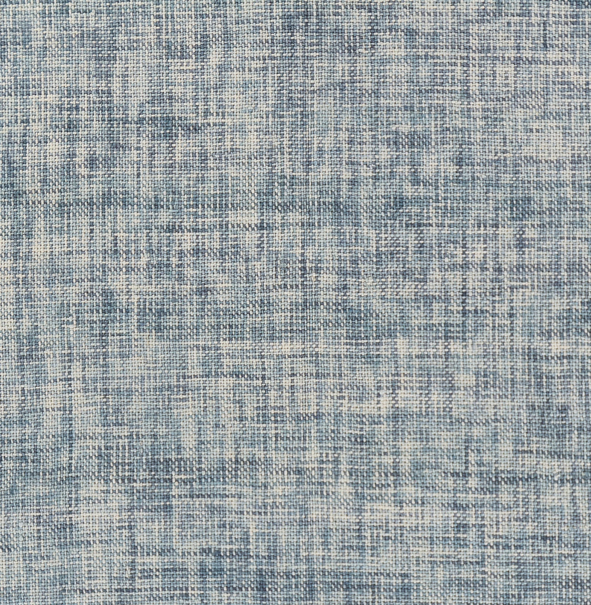 Blue woven rug with distressed abstract pattern; light cream and denim blue tones, linen-like texture.