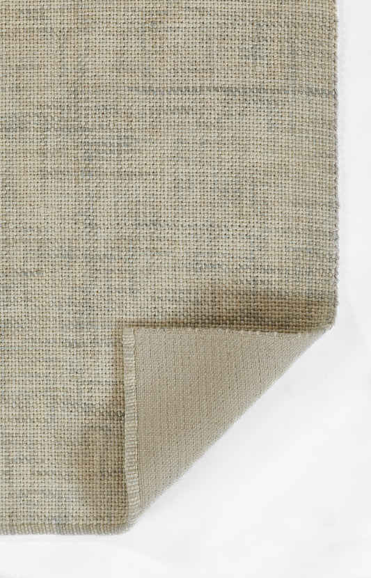 Beige-gray woven rug with natural fiber texture; folded corner reveals underside.