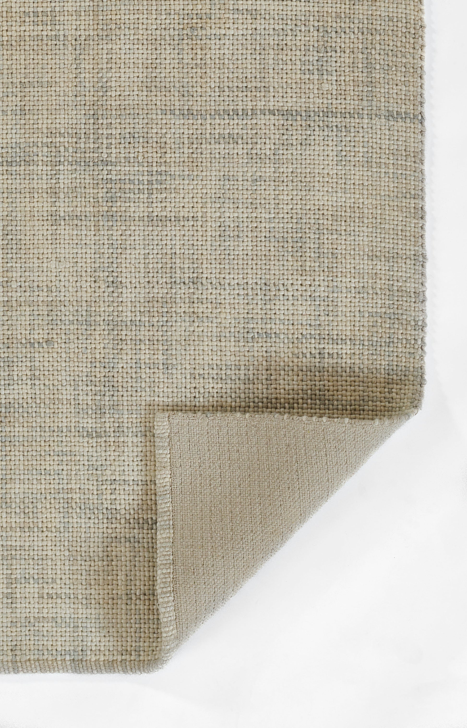 Beige rectangular woven rug with subtle gray patterns; natural jute look, folded corner shows soft tan backing.