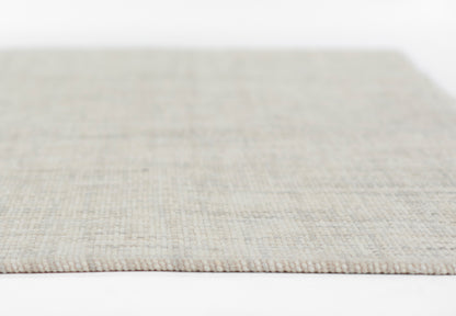 Beige-gray woven rug with soft loop texture, rectangular shape; neutral modern floor decor.