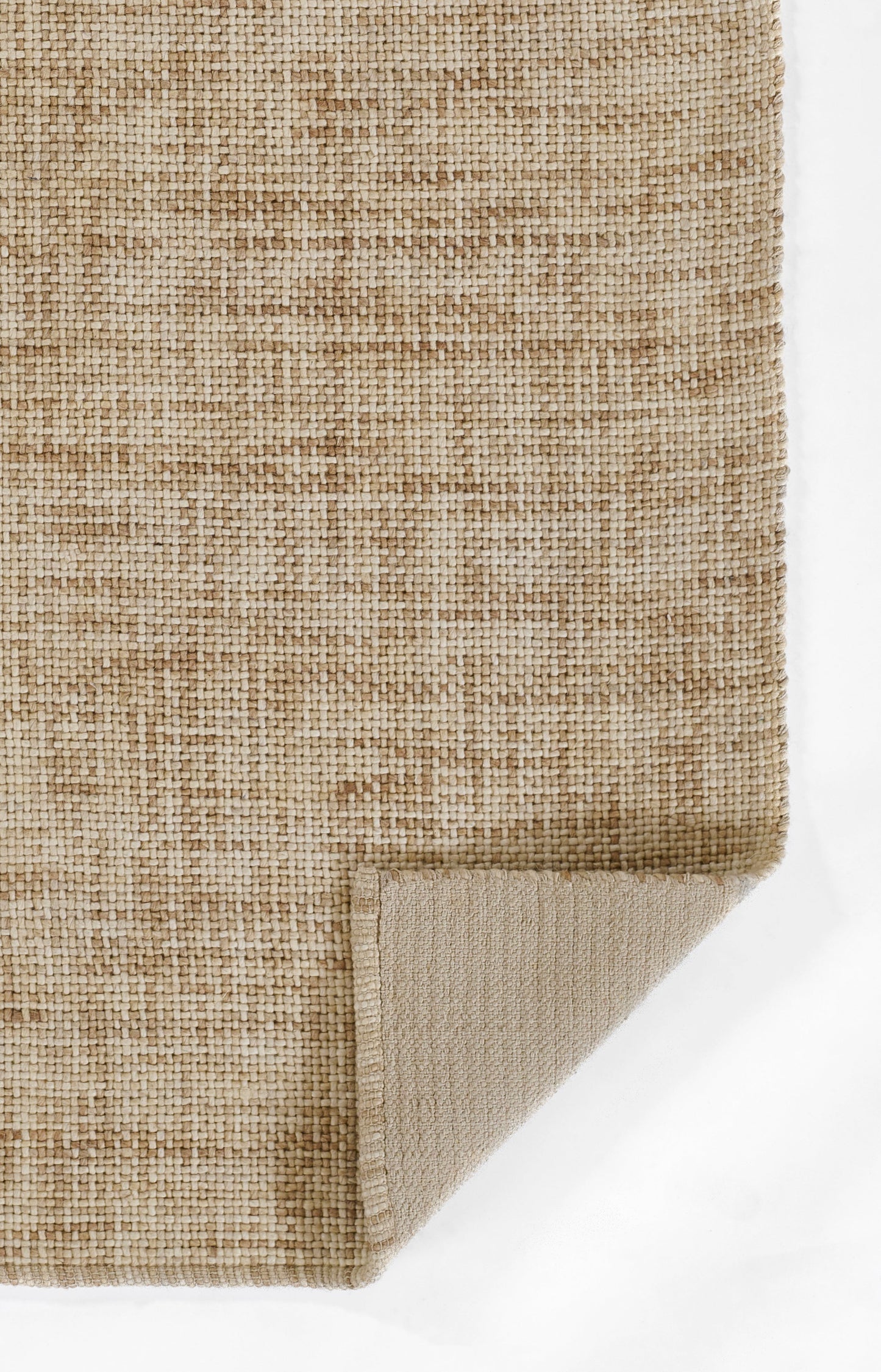 Natural tan jute rug with tight weave; flatwoven texture and folded corner revealing beige underside.