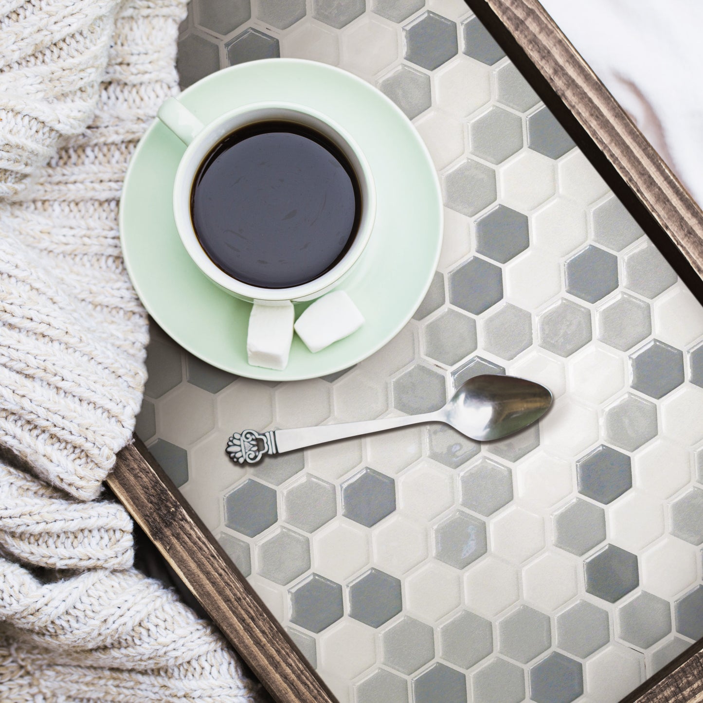 Grey hexagon tile wallpaper with a peel-and-stick backsplash pattern in a room setting.