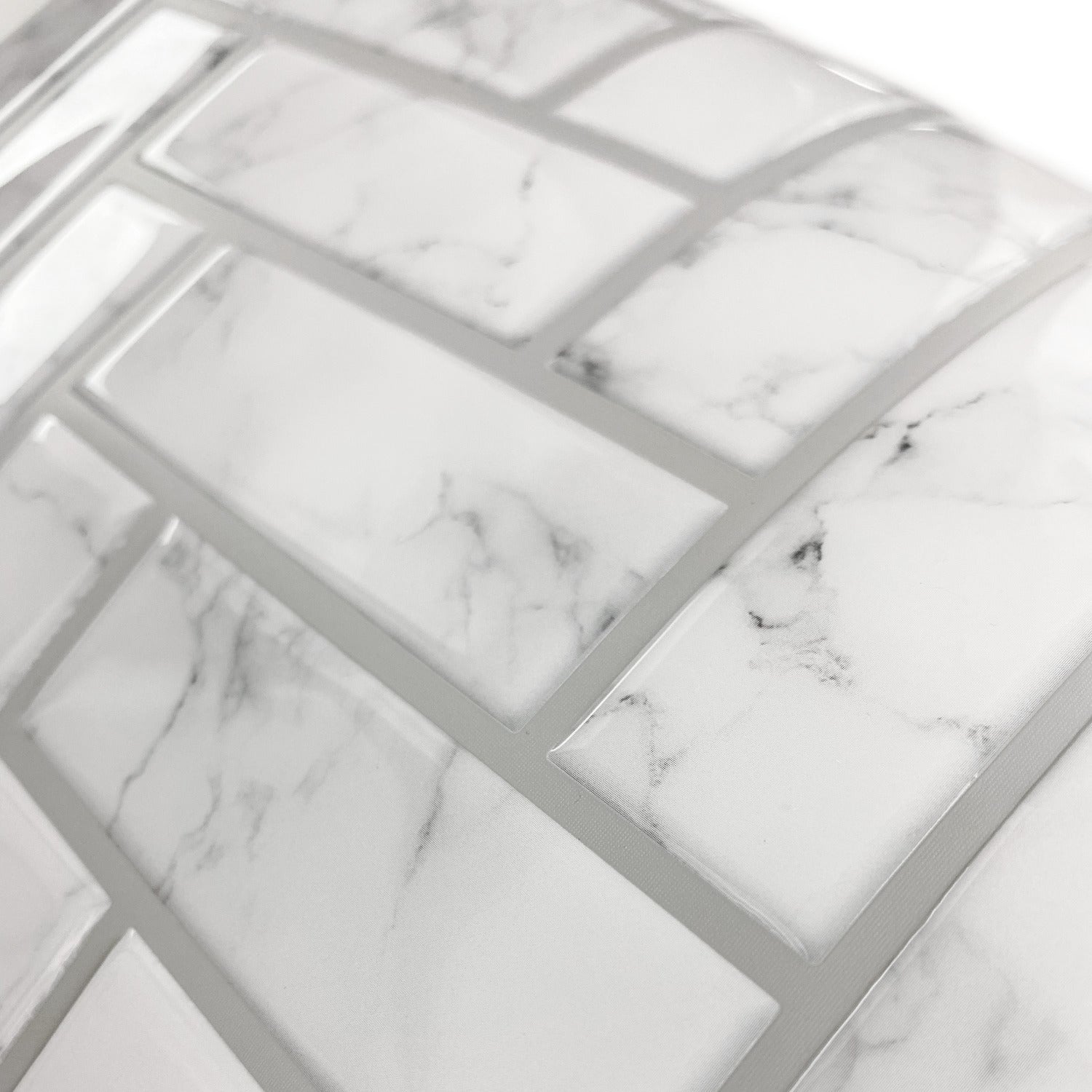Close-up of marble-look white and gray tile-like wallpaper sheet showing a mosaic pattern and thin gray grout lines.
