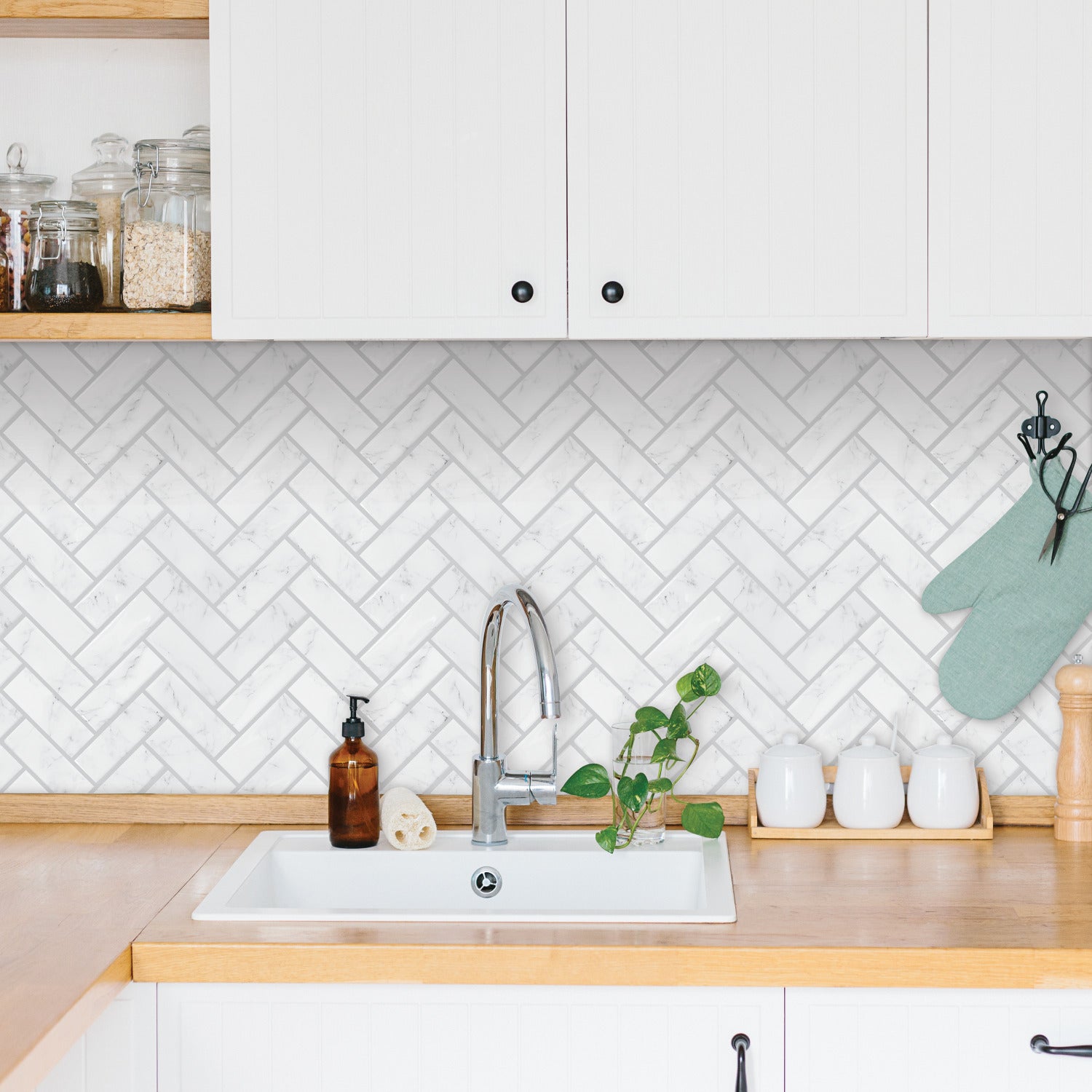 Whites and off-white marble herringbone wallpaper with a peel-and-stick finish.
