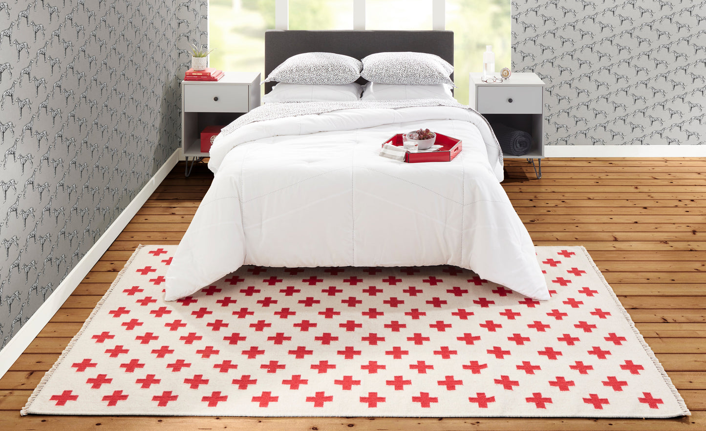 Cream rug with a red plus-sign pattern.
