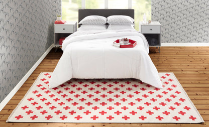 Cream rug with a red plus-sign pattern.