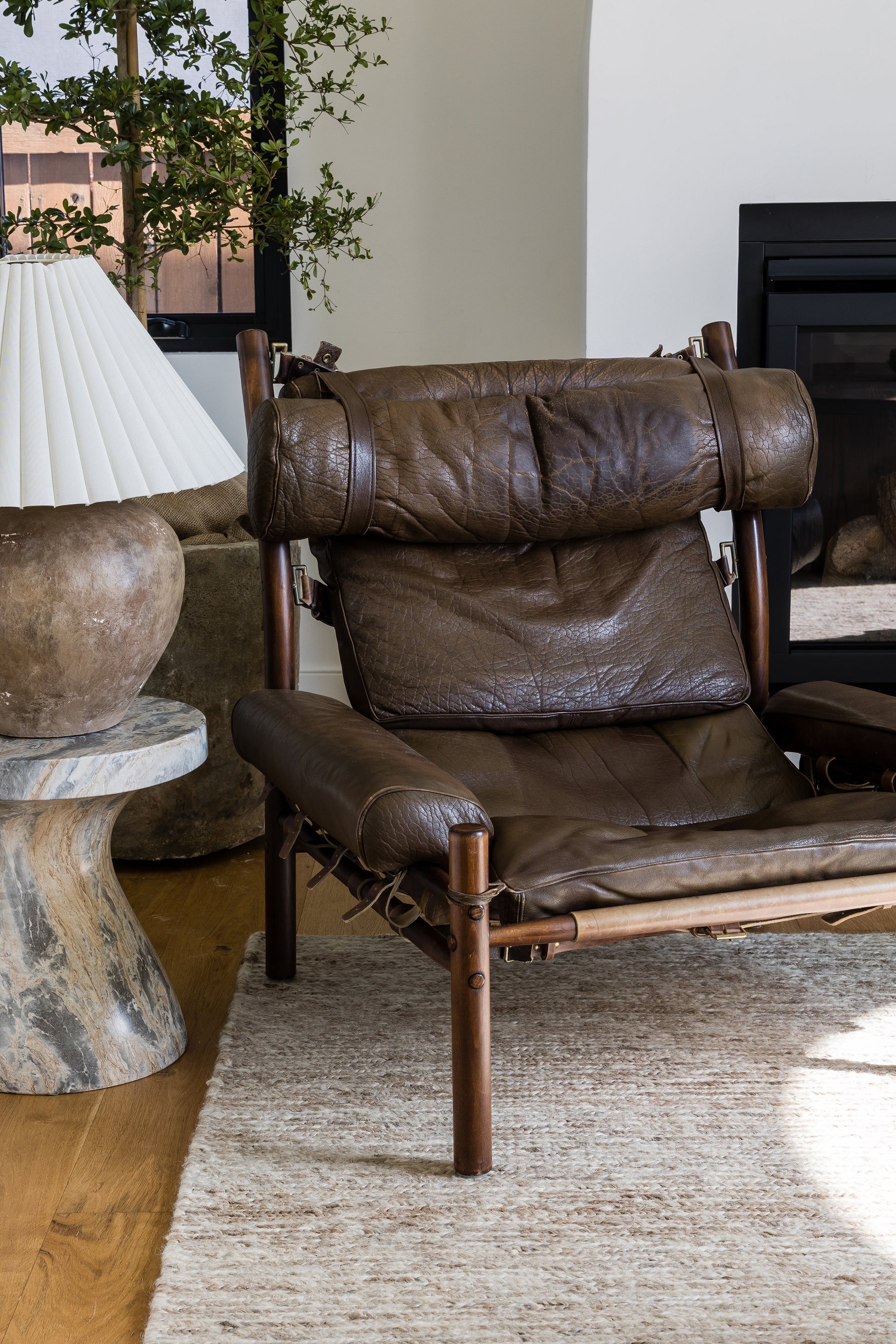 Brown round rug with a textured woven pattern in a living room.