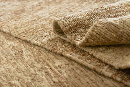 Beige natural fiber round rug with thick woven texture and rolled edge, 6 ft diameter, close-up view.