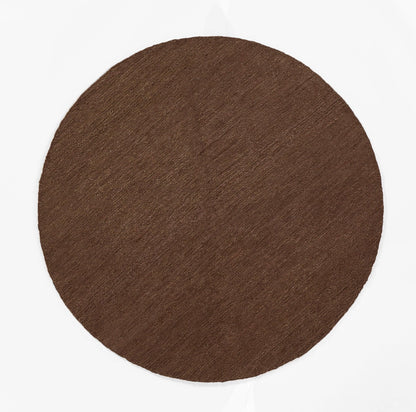 Round brown pressed pigment disc with matte finish; cocoa shade.